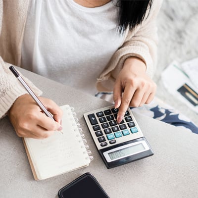 Hospitality Manager using a calculator